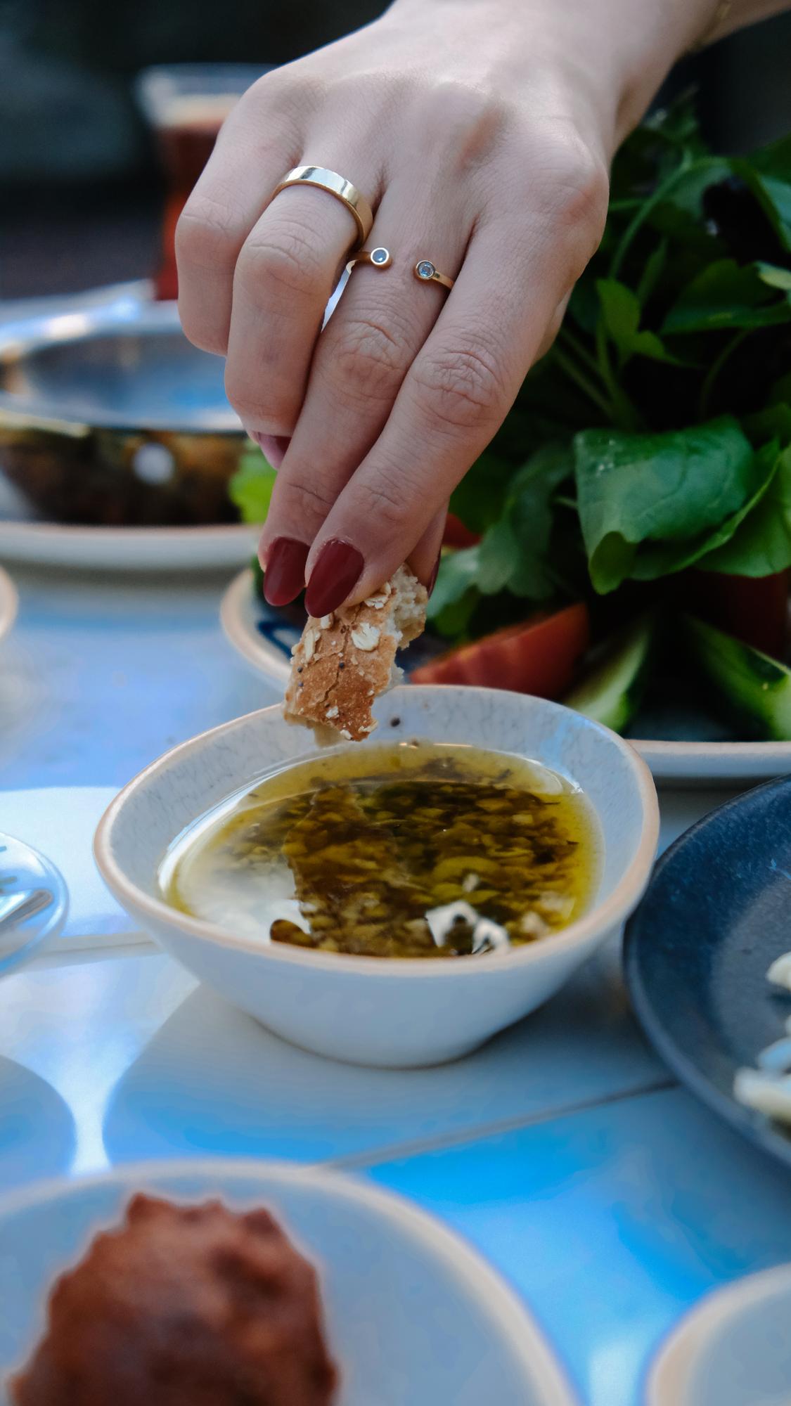 Close-up of hands seasoning a sauce